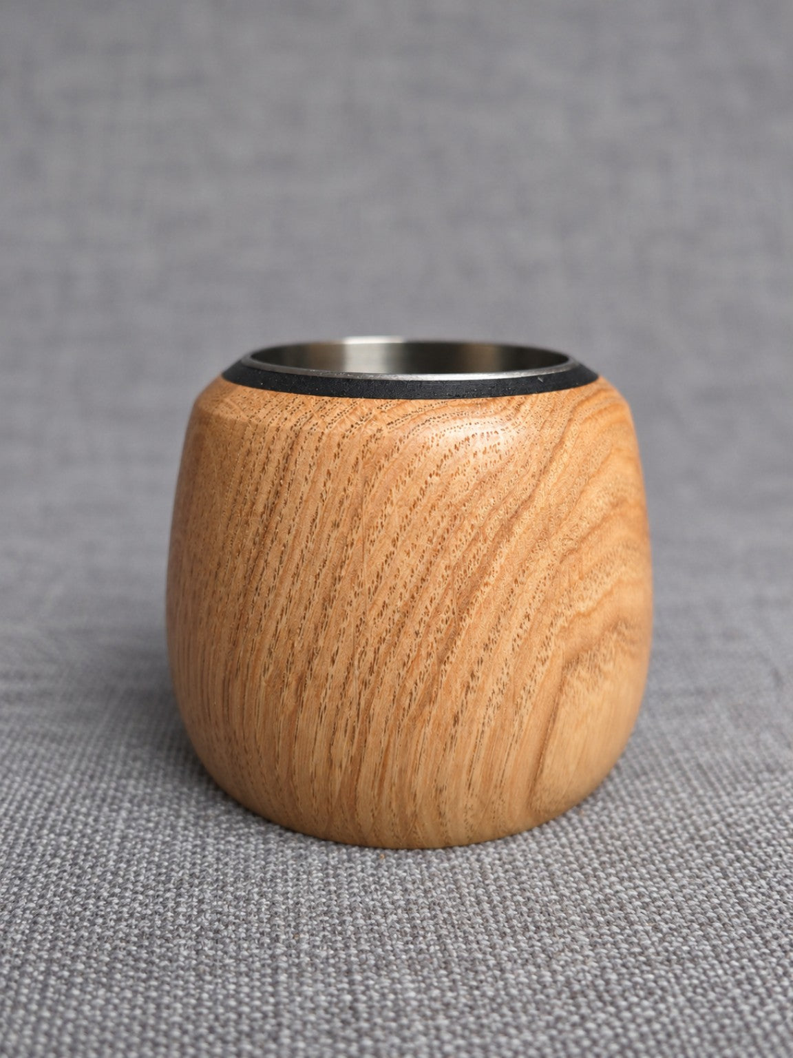 Front view of the oak tealight holder showing its natural grain and rounded shape