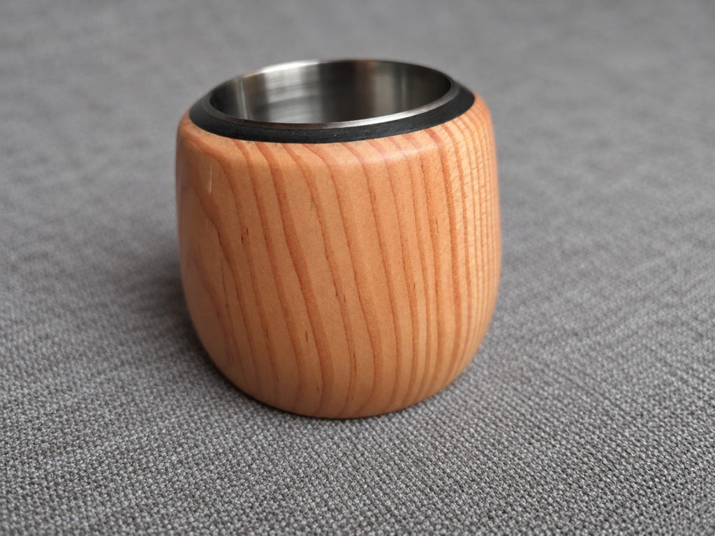 Close view of the warm pink and orange grain on a softwood holder from the trio